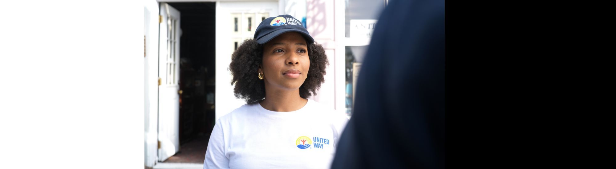 Woman in United Way shirt helping someone